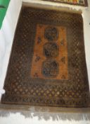 A golden Afghan rug, the three central m