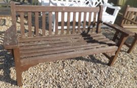 A slatted garden bench with wide arm res