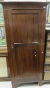 An Edwardian mahogany single door wardro