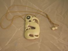 A bone Maori Hei-tiki style pendant as a bird with abalone shell eyes CONDITION REPORTS 7.5 cm