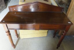 A Victorian mahogany hall table, the shallow arched back above a plain top and single end drawer