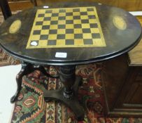 A walnut oval tilt top games table with