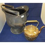 A Middle Eastern copper and brass kettle