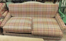A tartan covered two seater sofabed