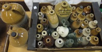 A large collection of stoneware bottles, to include examples inscribed "H G Jalland Wine & Spirit