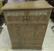 A 1930's limed oak and painted bedroom cabinet with two doors above four drawers in the manner of