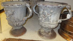 A pair of 19th Century lead twin handled garden urns of campana form  with scrolling handles cast