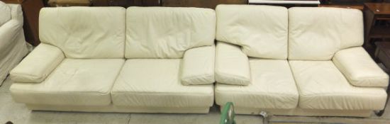 A cream leather three seat sofa, togethe