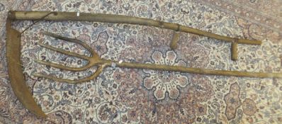 A long-handled scythe, together with a w