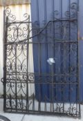 A pair of large black painted wrought iron gates with scroll and Gothic arch decoration CONDITION