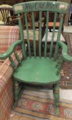 A green painted stick back rocking chair