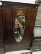 An Edwardian mahogany single door wardro