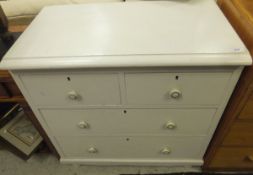 A white painted bedroom chest of two sho