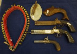 A 19th Century hammer action muff pistol, a pair of double barrel over and under hammer action