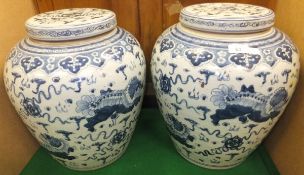 A pair of Chinese blue and white baluster shaped vases and covers in the 18th Century manner,