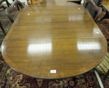 A reproduction mahogany drop-leaf D-end dining table on centre pedestal to quadruped base