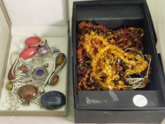 A box containing various amber necklaces