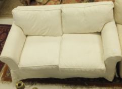 A two seater sofa in pale cream upholste