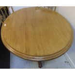 A modern mahogany oval centre table on t