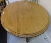 A modern mahogany oval centre table on t