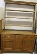 A pine dresser with three open shelves a