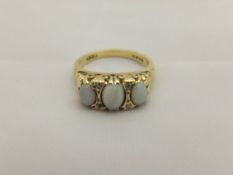 An 18ct gold and opal set ring CONDITION REPORTS General wear and scuffs and scratches.  Ring size