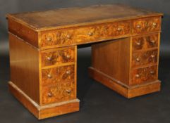 A Victorian burr walnut veneered double pedestal desk, the tooled and gilded leather insert