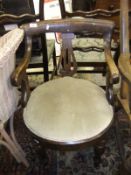 An oak framed elbow chair with cream uph