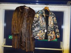 A three quarter length mink coat with br