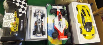 A Mika Hakkinen McLaren MP4-13 model car (boxed), on silvered plinth base, an Ayrton Senna one