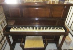 An early 20th Century rosewood cased upright piano, the iron framed overstrung movement by Rogers of