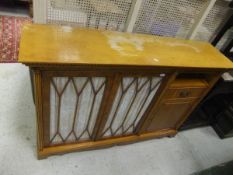 A yew veneered side cabinet with two gla