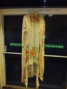 An early 20th Century silk shawl, the cream ground with embroidered floral decoration and tassels