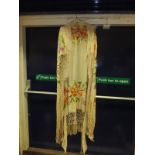 An early 20th Century silk shawl, the cream ground with embroidered floral decoration and tassels