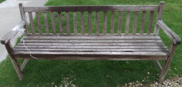 A teak slat back garden bench
