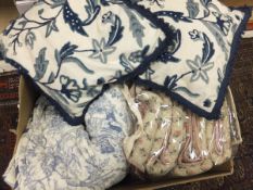 A box containing two quilted bedspreads,