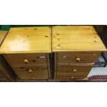 A pair of modern pine bedside tables wit