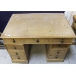 A late 19th / early 20th Century rectangular pine pedestal desk, the central drawer flanked by two