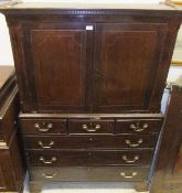 A 19th Century mahogany press cupboard, the upper section with moulded and dentil cornice over two