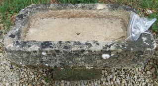 A natural stone rectangular trough on st