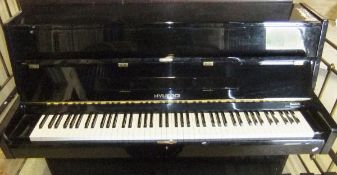 A modern black lacquered cased upright p