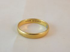 A 22ct gold wedding band CONDITION REPORTS Has wear and scuffs.  Size approx R.  Some very slight