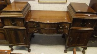 A Regency style mahogany serpentine fronted pedestal sideboard with acanthus leaf carving to