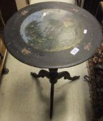 A Victorian ebonised tripod table with p
