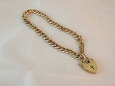 A 9ct gold bracelet with heart shaped lock CONDITION REPORTS Some general wear and scuffs and some