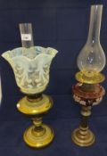 A late Victorian brass oil lamp with vaseline glass handkerchief shade and plain chimney, together