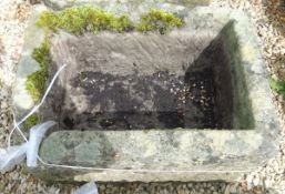 A natural stone rectangular trough