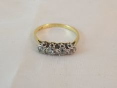 A four stone diamond and 18 carat gold dress ring CONDITION REPORTS Overall with wear, scuffs and