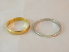 A 22 carat gold wedding band and a platinum wedding band CONDITION REPORTS Both with quite a lot