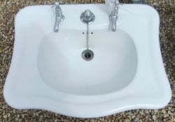 A vintage ceramic sink with taps by Grif